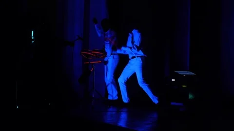2 men dance and play electronic drums during the laser show 動画素材 71340067