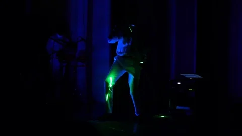 2 men dance and play electronic drums during the laser show Stock Footage 71340360