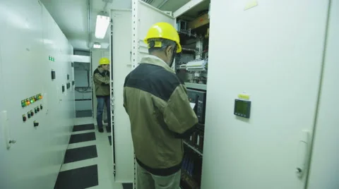 2 men make electricity metering equipment Stock Footage 68511878
