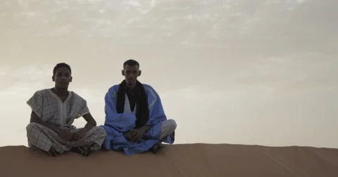 2 Men Sitting in the Desert at Sunset near Nouakchott, Mauritania (4K) Stock Footage 47997552