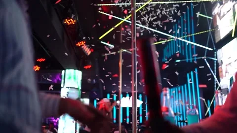 2 men throw confetti on the stage in a nightclub 4kSlowmotion Stock Footage 252591044