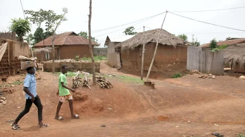 2 men walking in a small African village Stock Footage 158741101