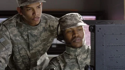 2 Military drone operators looking at computer screen 動画素材 70072458