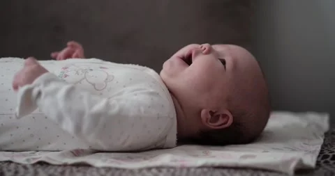 A 2-month-old child is lying on the couch Stock Footage 269503223