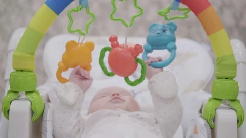 A 2-month-old child plays with toys Stock Footage 269503260