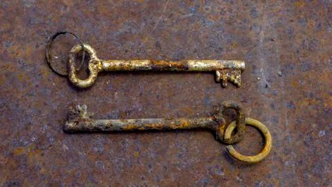 2 old rusty keys on ring shot on steel textured background. Copy space. Stock Photos