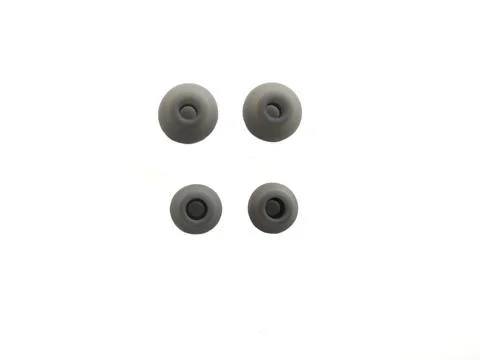 2 pairs of different size gray color earphone pads on white background Stock Photos