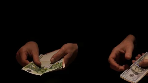 2 pairs of hands count Dollars and Euro on black background Stock Footage 72961526