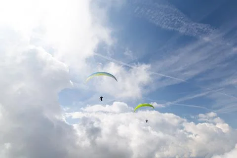 2 paraglides on the cloudy sky Stock Photos