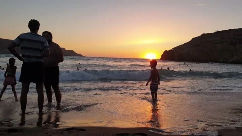 2 people talking by the beach at sunset Stock Footage 137523510