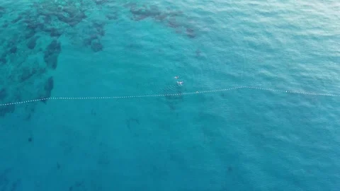 2 persons swimming on empty beach  Stock Footage 253504303