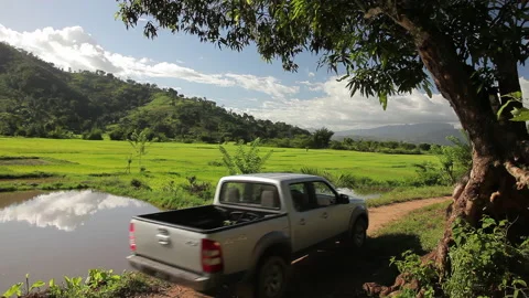 2 Pick-Up's on a field pass 4K Stock Footage 221130805