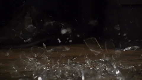 2 pieces of glassware falling to the ground and shattering in slow motion Stock Footage 101311452