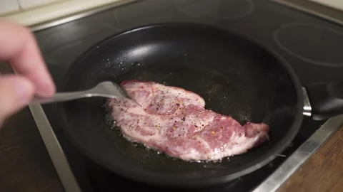 2 pieces of pork on the pan Stock Footage
