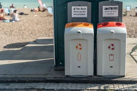 2 Plastic Bottle and Cans recycling bins on Brighton beach Stock Photos