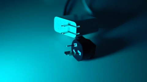 2 plugs of electronic devices lie on the table Stock Footage 267099983