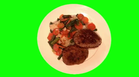 2 pork chops and stewed vegetables on plate, top shot Stock Footage 47575766