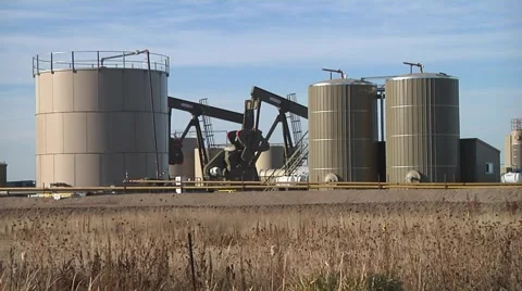 2 Pumping Units Looking Through Tanks Wide Stock-Footage 43044919
