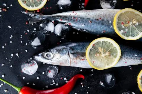 2  raw mackerel fish, ice cubes,  lemon slices, spices, red chili pepper, sal Stock Photos