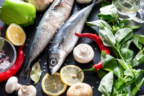 2 raw mackerel fish with lemon slices, Basil, chili pepper, mushrooms, salt   Stock-Fotos