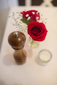 2 red roses on restaurant table Stock Photos