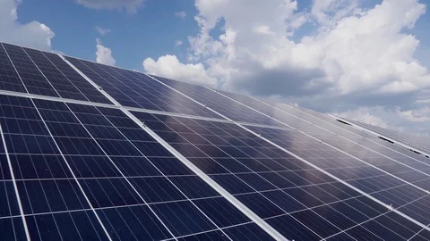 2 rows of solar silicon panels on a background of blue sky with clouds. Solar Stock Footage 113397477