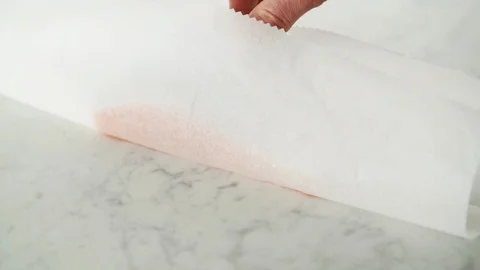 2 Salmon fillets opened from grease-proof paper on marble. Stock Footage 92144328