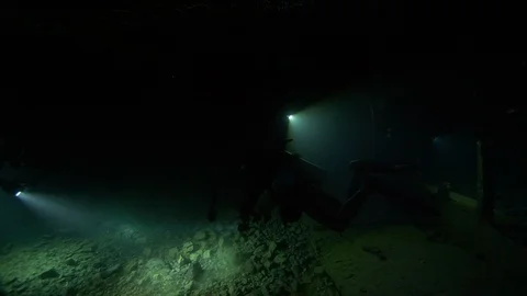 2 scuba divers light up the shipwreck Thistleghorm with Anthios, Red Sea, Egypt Stock Footage 105471646