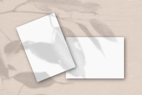 2 sheets of white textured paper against a peach wall. Mockup overlay with th Stock Illustration