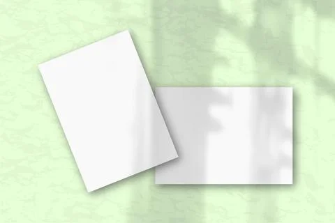 2 sheets of white textured paper against a gray wall. Mockup with an overlay  Stock Illustration