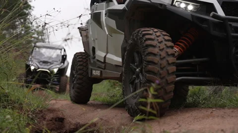 2 side by sides, rolling slowly down trail Stock Footage 243205310