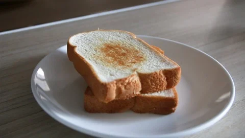 2 Slices of White Toasted Bread on White Plate Indoor Kitchen Stock-Footage 93899243
