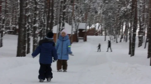 2 small child playing in the snow Stock Footage 70287656