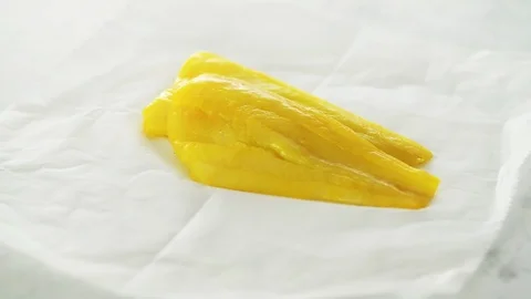 2 smoked haddock fillets on grease-proof paper on marble. Slight camera slide an Stock Footage 92145407