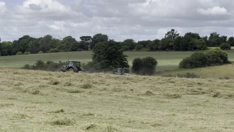 2 Tractors cutting grass Stock Footage 204871214