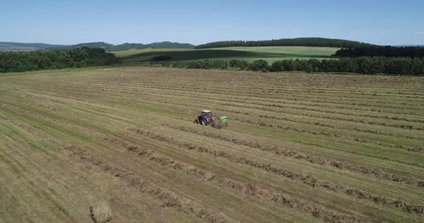 2 tractors in field with haystacks Stock Footage 102286250