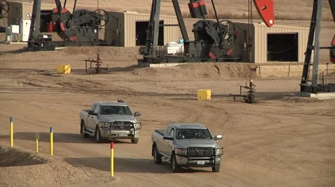 2 Trucks Leave a Large Well Site 스톡 동영상 43028065