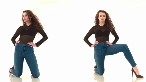 2 videos in one. Curly-haired girl in black body and jeans kneeling on a white Stock Footage 85312088