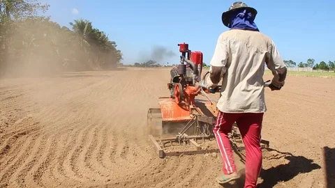 2 wheel hand tractor plowing field Stock Footage