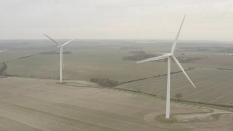 2 Wind turbines in a field, one is spinning. 4K D-Log 動画素材 149977708