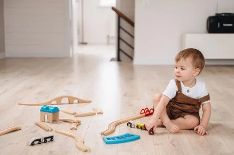 A 2-year-old boy playing on the floor at home Stock Photos
