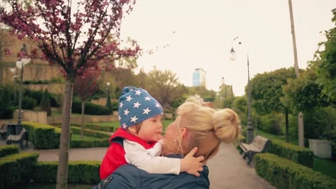 A 2-year-old boy is smiling in his mother's arms. Stock Footage 153559654