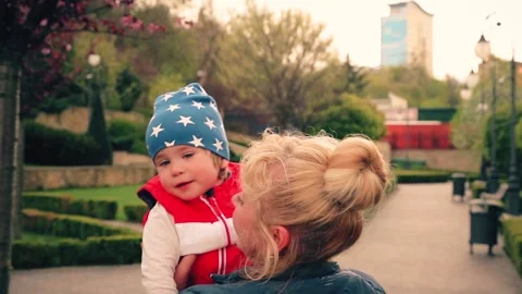 A 2-year-old boy is smiling in his mother's arms. Stock Footage 153559703