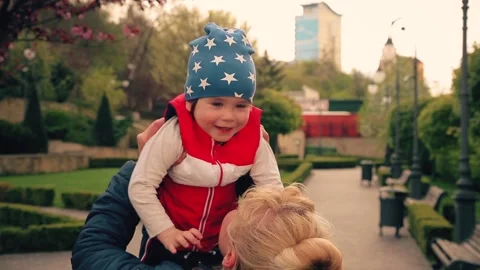 A 2-year-old boy is smiling in his mother's arms. Stock Footage 153559747