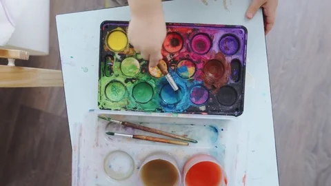 2 year-old child paints with watercolors Stock Footage 84789034
