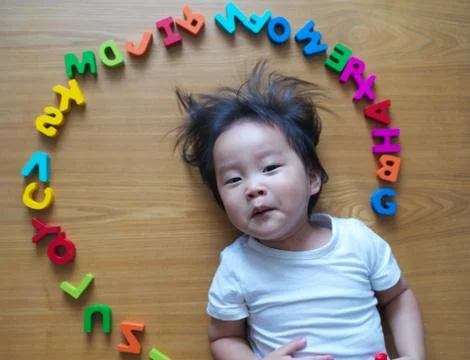 2 year old child playing with alphabets Stock Photos