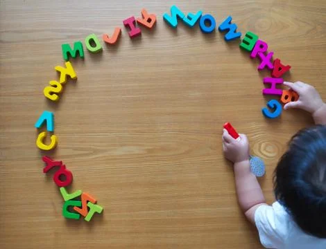 2 year old child playing with alphabets Stock Photos
