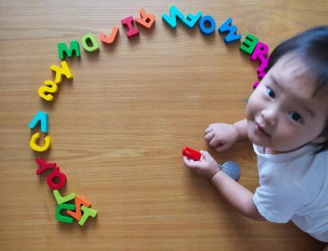 2 year old child playing with alphabets Stock Photos