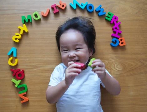 2 year old child playing with alphabets Stock Photos