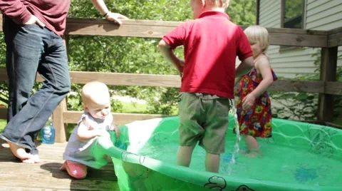 2 year old figures out how to spray hose water Stock Footage 40028795